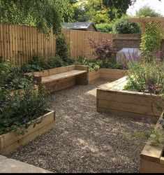 an outdoor garden with wooden benches and plants