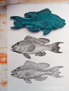 two fish are shown next to each other on a piece of white paper with blue ink