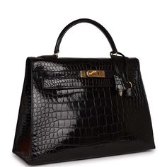 This Kelly is in Black shiny niloticus crocodile with gold hardware and features tonal stitching, a front toggle closure, a clochette with lock and two keys and a single rolled handle.The interior is lined with black chevre and features one zip pocket with an Hermes engraved pull and two open pockets on the opposite side.Collection: T CircleOrigin: FranceCondition: Excellent -This bag retains its structure, scuffing throughout bag, minor pressmarks to underside of flap and interior lining, no pl Birkin Mom, Hermes Kelly Sellier, Spoiled Wife, Kelly Sellier, Hermes Kelly Bag, Kelly Bag, Vintage Hermes, Money Bag, Hermes Bags