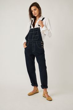 So essential and forever timeless, these special denim overalls from Free People's We The Free collection are featured in a relaxed, slouchy silhouette with tapered legs and exaggerated pocket detail for added dimension. Note: Size and placement of distressing may vary slightly. 100% Cotton Machine wash cold Measurements for size small Inseam: 29.5 in Hips: 41.5 in Rise: 11.5 in Waist: 34 in Utility Overalls With Relaxed Fit For Everyday, Everyday Dark Wash Overalls With Pockets, Utility Denim Jumpsuit For Everyday, Dark Wash Straight Leg Overalls For Work, Dark Wash Workwear Overalls, Casual Bib Front Jeans For Workwear, Workwear Bib Front Jeans With Pockets, Workwear Jeans With Bib Front And Pockets, Workwear Bib Front Jeans