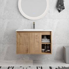 a bathroom with a sink, mirror and towel rack on the wall next to it