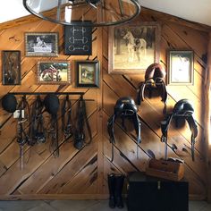 there are many helmets on the wall in this room