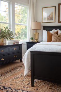 a bedroom with a bed, dresser and window