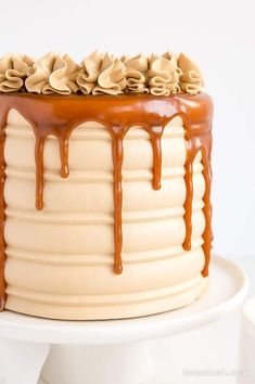 there is a cake with chocolate icing on the top and drizzled in caramel