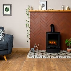 a living room with a fire place in the corner and a chair next to it