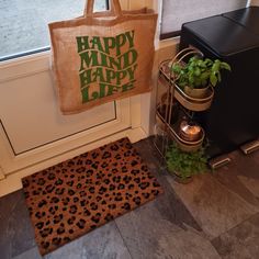 a brown bag sitting on top of a door mat next to a window sill