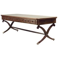 a wooden table with two drawers on one end and a marble top on the other