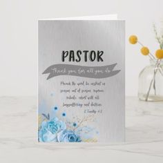 a card with the words pastor on it and flowers in a vase next to it