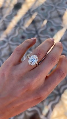 a woman's hand with a diamond ring on it