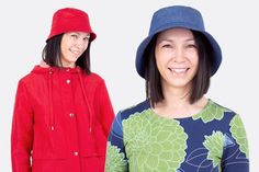 two young women wearing hats and smiling at the camera