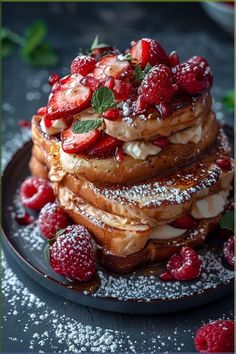 a stack of french toast topped with strawberries and powdered sugar