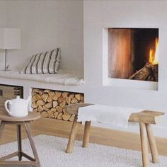 a living room filled with furniture and a fire place next to a wall mounted fireplace