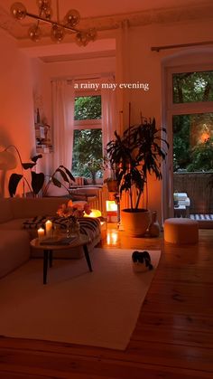 a living room filled with lots of furniture and candles on the floor next to a window