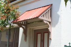 a white house with a red roof and window