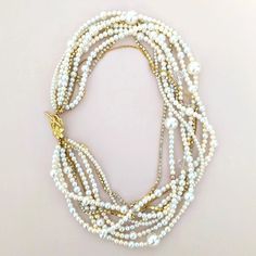 This chunky pearl necklace will be perfect for a wedding gown or long after to wear as a statement piece. I designed the necklace in bohemian elegance. The subtle color tone of the necklace will help you wear it from white to any color outfit, and the sparkles also will be enough for your wedding day or any daily events. DETAILS●Handmade in my studio● Ivory, white, cream, and a couple of golden brown color glass pearls, crystals, and rhinestone chains● Finished off a silver heart toggle, gold fi Elegant Multi-strand Pearl Necklace, Elegant Pearl Necklace With Chain For Wedding, Elegant Wedding Pearl Necklace With Chain, Elegant Multi-strand Pearl Charm Chain Necklace, Elegant Multi-strand Chain Necklace With Pearl Charm, Multi-strand Pearl Chain Necklace, Elegant Multi-strand Chain Necklace For Wedding, Elegant White Beaded Necklace With Chain, Pearl Beaded Chain Necklace For Wedding