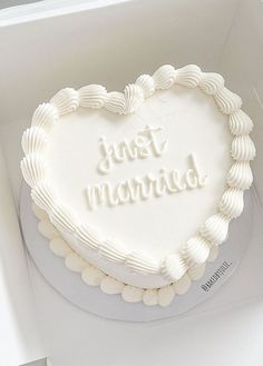 a heart shaped cake with the words just married written on it in white frosting