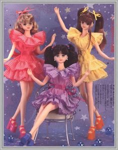 three dolls sitting on top of a chair in front of a purple background with stars