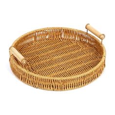 a round wicker tray with two handles on the bottom and one handle at the top