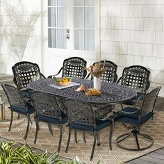 an outdoor table and chairs on a patio