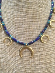 "Ancient style Lunula or Crescent moon necklaces with a variety of genuine gemstone options! Beautiful 22k gold plated pendants to compliment your ancient Roman, Greek, Parthian, Coptic or any other Bronze age persona! You can wear them with your prettiest T shirt and jeans outfit. Earrings that compliment these necklaces can be found in my Etsy shop here. https://www.etsy.com/listing/817662134/ancient-style-lunula-crescent-mooref=shop_home_active_2 These necklaces are finished with 14k gold fil Celestial Crescent Jewelry For Healing, Traditional Gold Jewelry With Lapis Lazuli, Artisan Crescent Jewelry Hand Forged, Artisan Hand Forged Crescent Jewelry, Bohemian Crescent Necklaces For Jewelry Making, Celestial Crescent Jewelry For Meditation, Celestial Crescent Necklaces For Healing, Spiritual Crescent Jewelry For Jewelry Making, Celestial Style Gold Necklace With Natural Stones