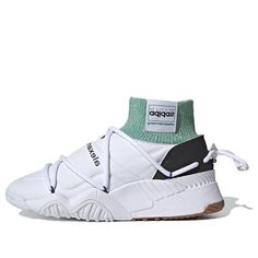 The Adidas Alexander Wang x Puff Trainer 'Core White' is a stylish and comfortable sneaker that is perfect for everyday wear. Made with a synthetic leather upper, this shoe is durable and easy to clean. The tonal stitch detailing gives the shoe a 'puffer' effect, while the green sock-like collar adds a pop of color. The woven logo tag and inverted Trefoil branding add a touch of luxury to this shoe. The oversized drawcord lacing system ensures a secure fit, while the gum rubber outsole provides excellent traction. (SNKR) Adidas Sporty Sneakers With Rubber Sole, Sporty Lace-up Basketball Shoes With Vulcanized Sole, Adidas Sporty Custom Sneakers With Rubber Sole, Adidas Custom Sporty Sneakers With Rubber Sole, Adidas High-top Sneakers With Vulcanized Sole For Streetwear, Dynamic Sneakers For Light Sports With Textured Sole, Athleisure High-top Chunky Sneakers With Cushioned Footbed, Sporty Slip-on High-top Sneakers With Vulcanized Sole, Adidas Sporty Sneakers With Textured Sole