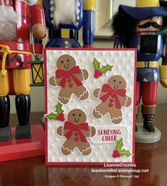 a close up of a christmas card on a table with nutcrackers in the background