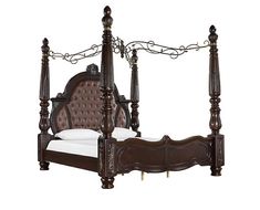 a bed with four posts and white sheets