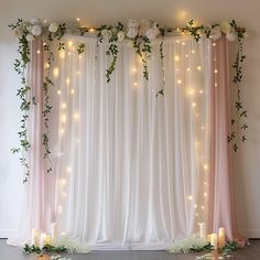 a wedding backdrop with flowers and candles