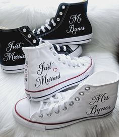 three pairs of white and black high top sneakers with the words just married written on them