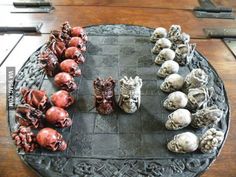 there are many skulls and heads on the trays that have been made into chess pieces