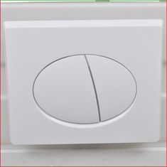 a close up of a white button on a wall