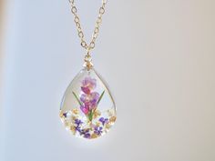 This necklace features Gladiolus, the birth flower for August, carefully preserved in a clear resin pendant. Gladiolus is symbolic of strength of character, faithfulness, moral integrity, and remembrance, making this necklace a perfect personalized birthday gift. Material: 14k gold filled chain and components or Silver, Resin Flower: Real Pressed Flower Chain Length: 18" (45cm)  Pendant Width: 0.79" (2cm) Pendant Height: 0.98" (2.5cm) Every pieces is made by hand and unique, therefore each piece Clear Flower Shaped Birth Flower Jewelry, Clear Flower-shaped Birth Flower Jewelry, Clear Flower Pendant Necklace As Gift, Clear Flower Pendant Necklace For Gift, Clear Necklace With Pressed Flowers For Gift, Clear Necklaces With Pressed Flowers As A Gift, Clear Necklaces With Pressed Flowers For Gifts, Clear Flower-shaped Necklace For Gift, Clear Flower Necklace For Gift