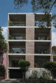 an apartment building with balconies on the second floor