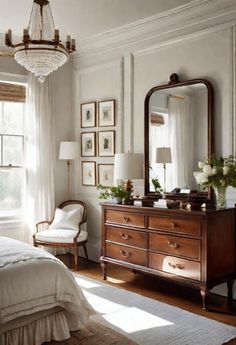 a bedroom with a bed, dresser and mirror in it's centerpieces