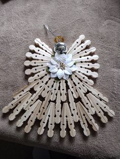 an ornament made out of wooden sticks and flowers