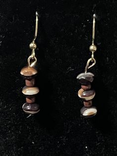 Hello and welcome to my store! You are looking at a pair of brown and white disc earrings. They have brown and white beads that are shaped like discs and brown seed beads. The disc beads are made of czech glass. These earrings dangle to 1.5 inches long and they are on gold fishhooks. I will include earring backs upon purchase. Thanks for looking! Brown Dangle Earrings With Colorful Beads, Brown Metal Beaded Dangle Earrings, Brown Dangling Round Beads Jewelry, Beaded Brown Czech Glass Earrings, Nature-inspired Brown Round Bead Jewelry, Unique Brown Earrings With Dangling Beads, Brown Beaded Czech Glass Earrings, Brown Czech Glass Earrings With Dangling Beads, Brown Czech Glass Bead Earrings