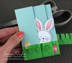 a person holding up some paper with an easter bunny on it