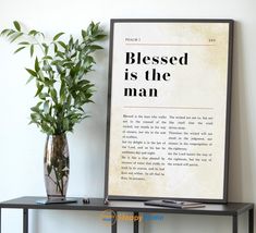 a plant is sitting on a shelf next to a framed poster that says, blessing is the man