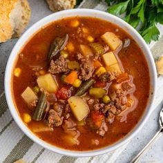 a white bowl filled with soup next to bread