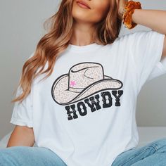 Howdy, partner! Get ready to wrangle up some Western charm with our "Howdy Cowboy Hat" Comfort Color Tee, the perfect pick for those who love the rugged allure of cowboy culture. Crafted for individuals who embrace the spirit of the frontier, this tee exudes casual style and cowboy cool. Made from premium Comfort Color fabric, our tee ensures both softness and durability, promising comfort whether you're out on the ranch or hitting the town. The "Howdy Cowboy Hat" design captures the iconic imag White Western T-shirt For Rodeo, Western White T-shirt For Country Events, Western Style White T-shirt For Country Events, White Western Tops For Country Events, Casual White Tops For Country Events, Western White Tops For Rodeo, Trendy White Tops For Ranch, Cowboy Culture, Cowboy Hat Design