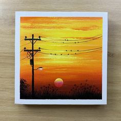 a painting of birds sitting on power lines in the distance with an orange sunset behind them