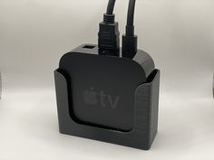 an apple tv charger with two cables attached to it