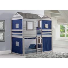 a child's bunk bed with a blue tent on the top and bottom floor