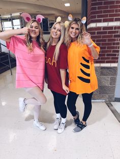 three girls in costumes posing for the camera with their hands on their hipss and arms behind their backs