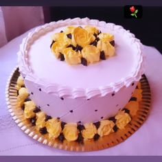 a white cake with yellow flowers on top