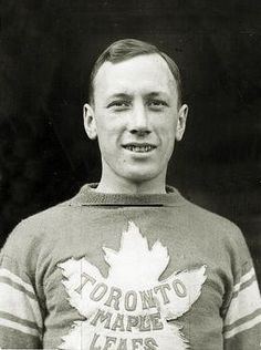 an old black and white photo of a young man wearing a canadian maple leaf sweater