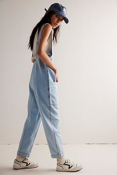 One-and-done and so simple, this denim jumpsuit from our We The Free Collection is featured in a relaxed fit and cropped ankle-length style with harem legs and a low scoop neckline. **Fit:** Slouchy, relaxed fit; ankle-length, pull-on style **Features:** Denim fabrication, rigid feel, low scoop neckline, seam detail throughout, oversized patch pockets, drop-crotch harem-style legs, low back with adjustable shoulder straps **Why We | We The Free High Roller Jumpsuit at Free People in Light Wash, Free People High Roller Jumpsuit Outfit, Free People High Roller Jumpsuit, High Roller Jumpsuit Outfit, Free People Overalls Outfits, Free People Jumpsuit Outfit, Free People Jumpsuit, Modest Clothes, High Roller, 2024 Style