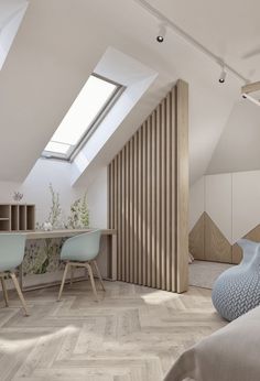 an attic bedroom with wooden slats and skylights above the bed, along with two desks