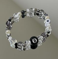 A bracelet crafted with alternating black and clear beads, strung together on a stretchy cord for a flexible and comfortable fit. The contrast between the black and clear beads creates a sleek and stylish look. MEASUREMENT: 16 centimeters (6.2 inches) IMPORTANT NOTE: - Avoid wearing the bracelet while swimming or showering to prevent water damage and weakening of the elastic. - Be gentle when putting on or taking off the bracelet to avoid overstretching the elastic. 8 Ball Bracelet, Trendy Adjustable Black Crystal Bracelet, Trendy Black Beaded Bracelets With Letter Beads, Casual Black Stretch Bracelet With Letter Beads, Casual Black Crystal Bracelet With Round Beads, Trendy Black Bracelets With Letter Beads, Casual Black Round Stretch Bracelet, Black Stretch Bracelet With Letter Beads, Black Stretch Bracelet With Letter Beads And Round Beads