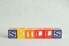 the word skills spelled out in wooden blocks